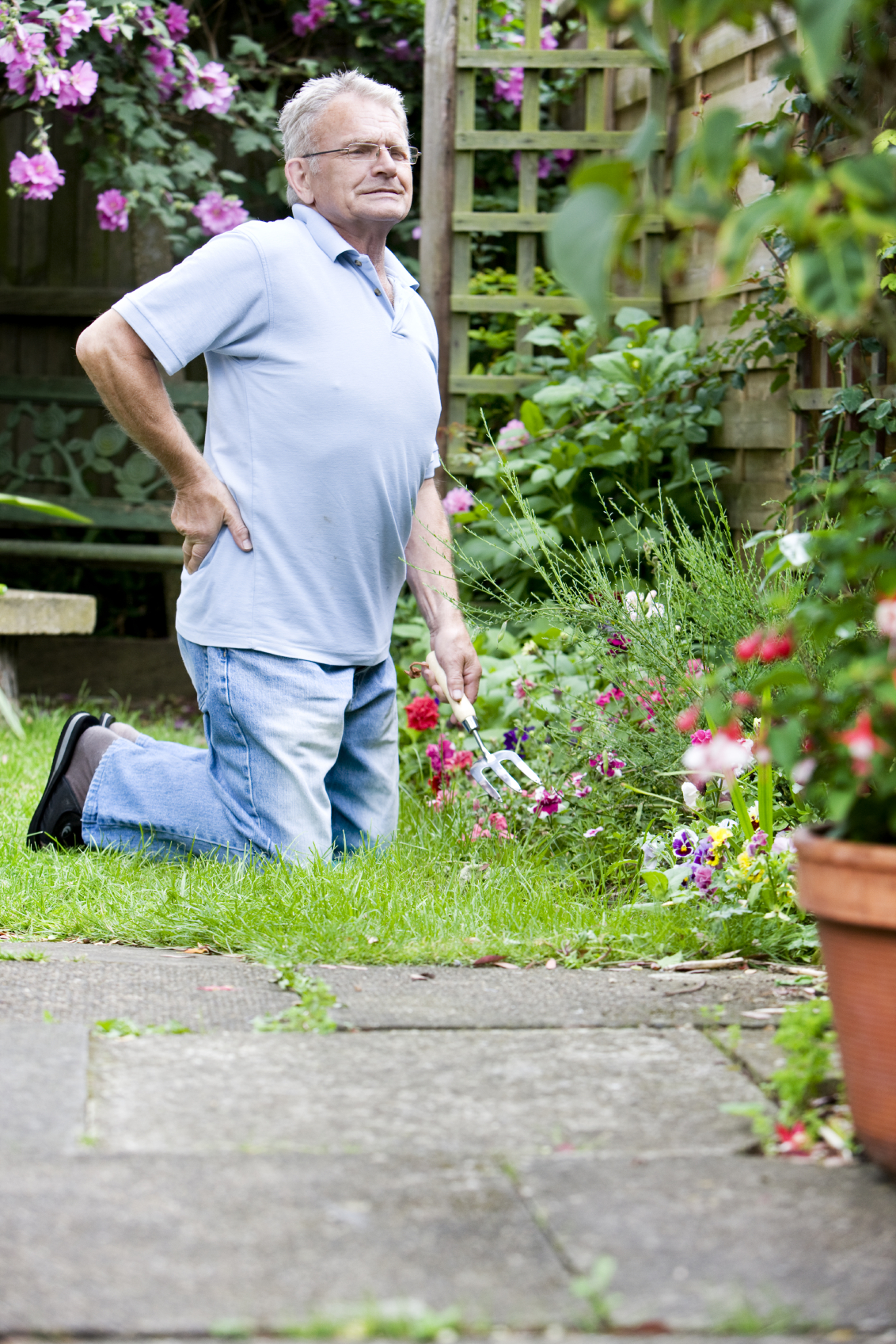 Man with back pain trying to garden