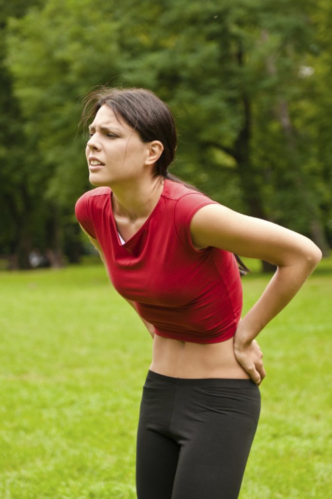 Woman athlete with back pain in Omaha